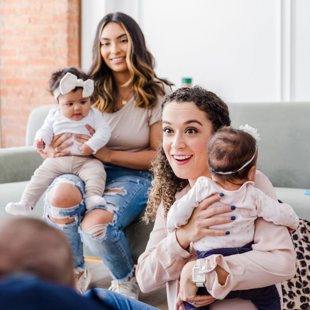 two mothers holding their babies at a support group